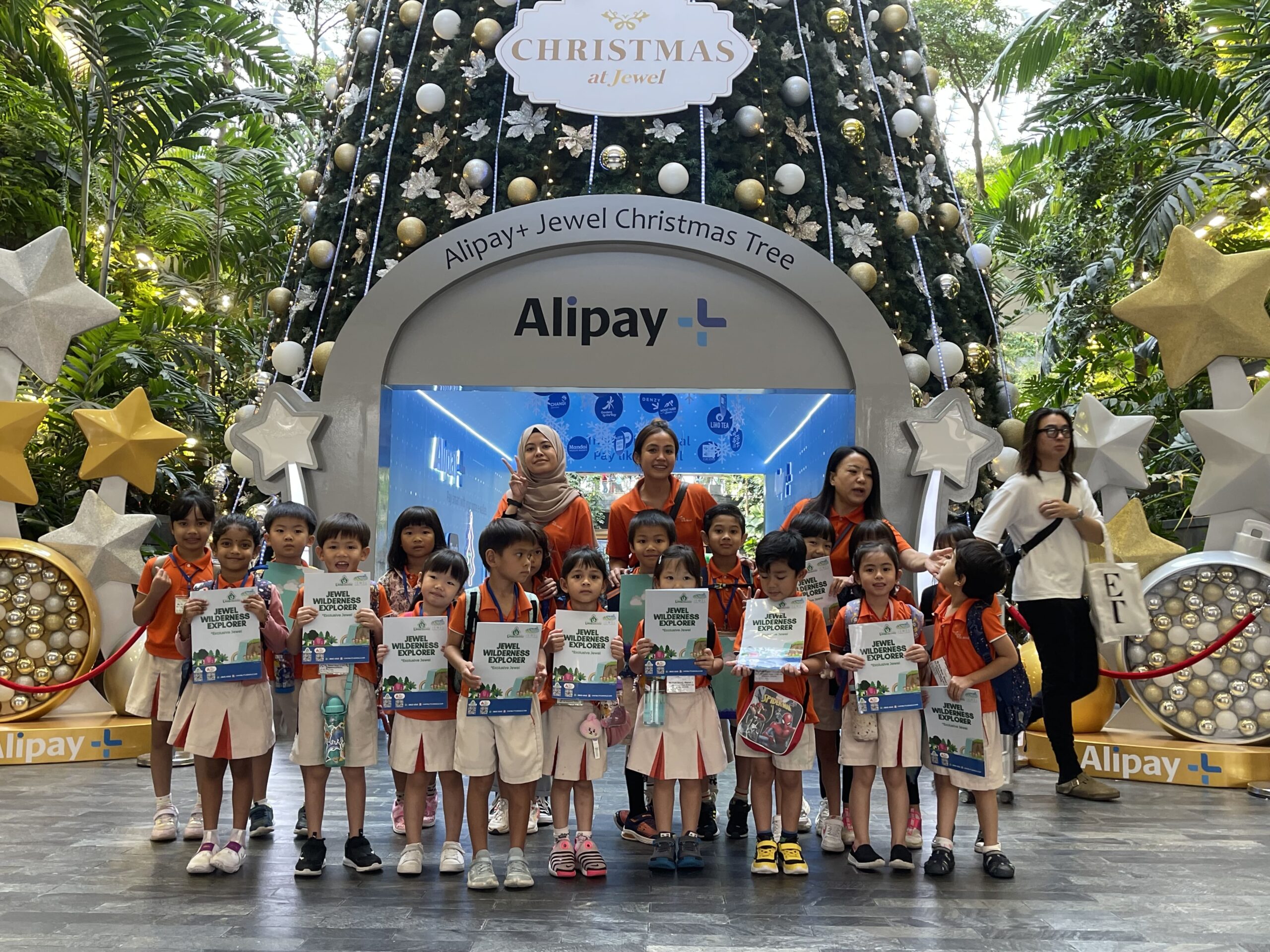 Children holding Wilderness Explorer booklets in Jewel