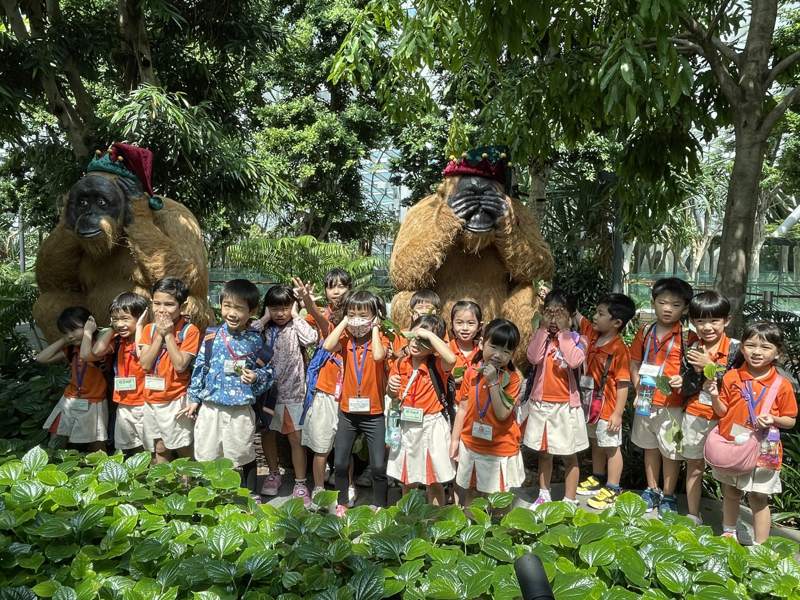 Children with festive rainforest mascots at Jewel