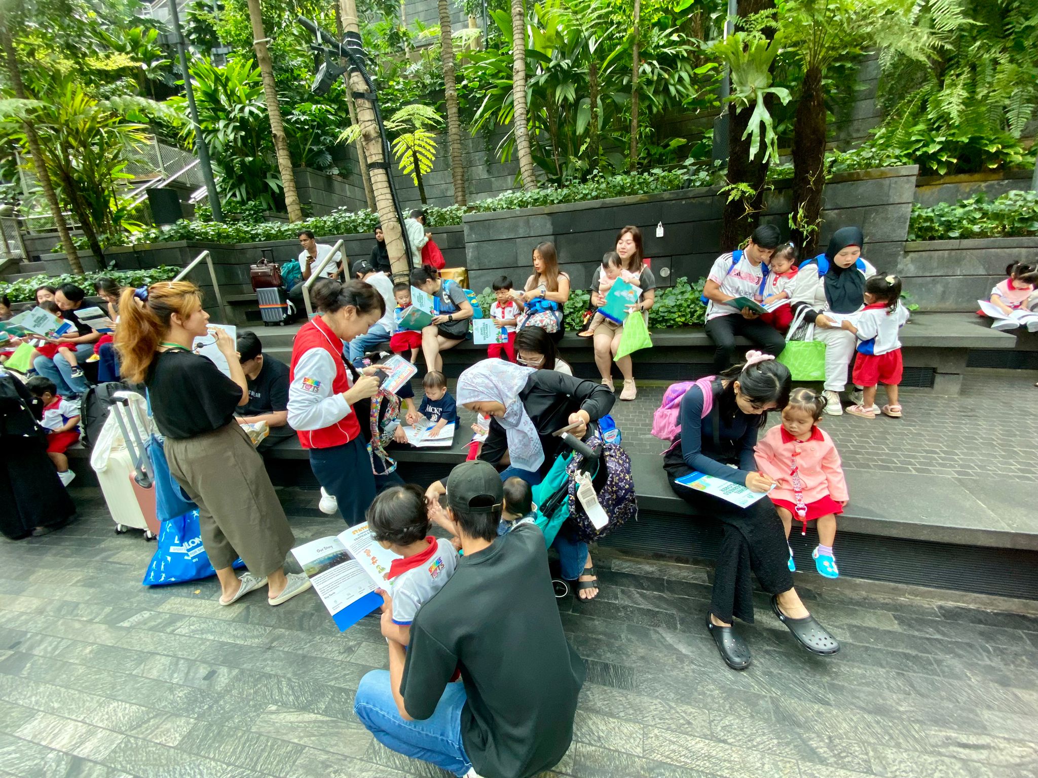 Sparkletots holding rainforest activity sheets