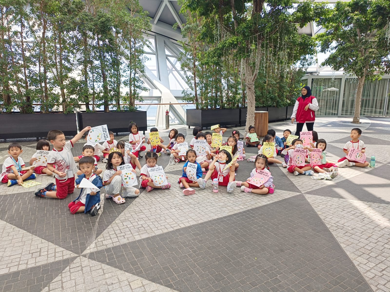 Children walking through Jewel indoor greenery